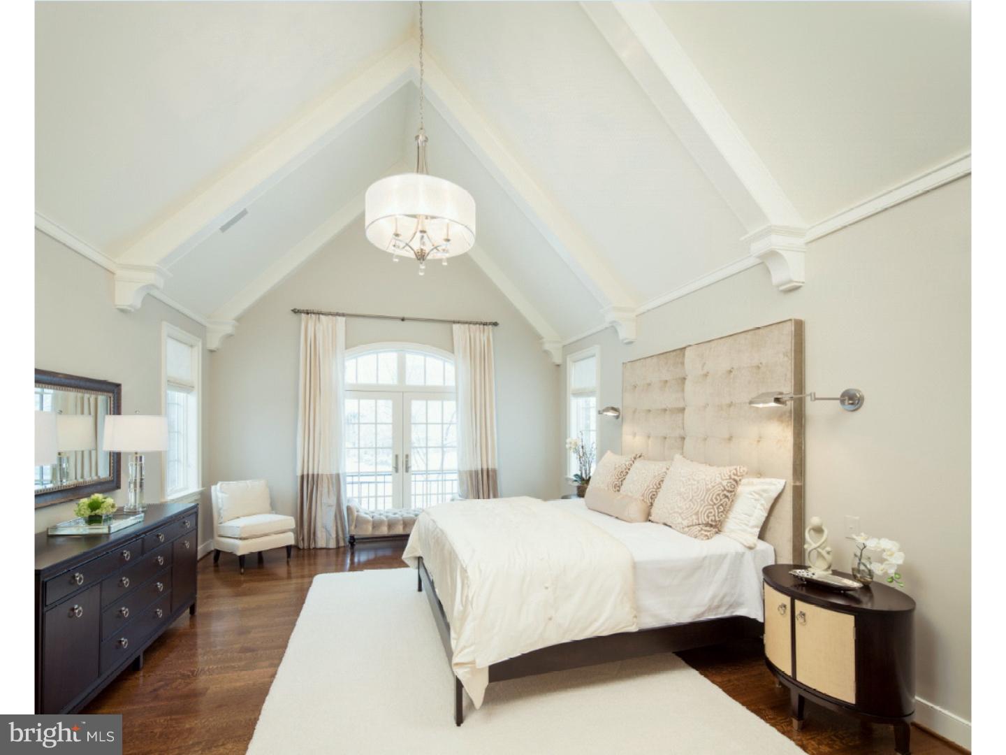 220 South Waterloo Road Devon, PA 19333 - Photo 10 of 13 a bedroom with a large bed and wooden floor