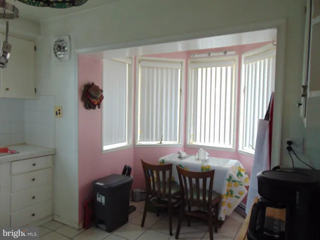 a view of a dining room with furniture and window