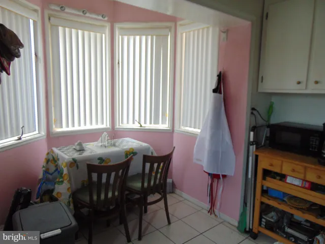 a dining room with furniture and a window