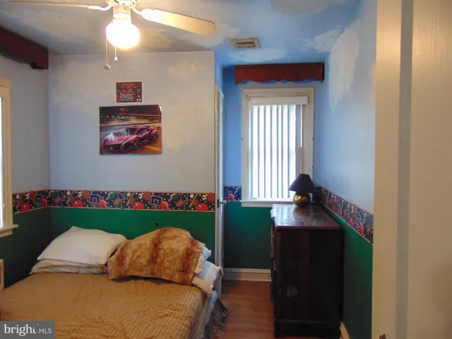 a bedroom with furniture and a window