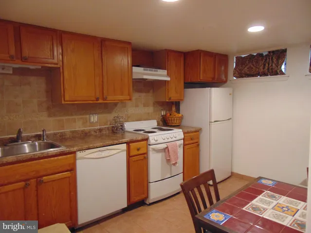 a kitchen with a sink appliances and cabinets