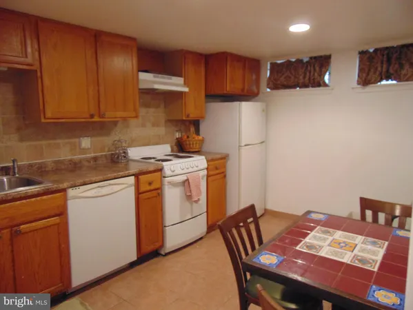 a kitchen with a sink appliances and cabinets