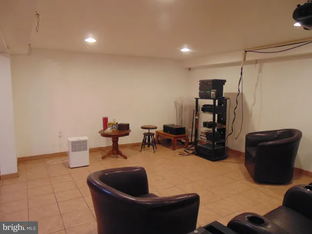 a living room with furniture and a lamp