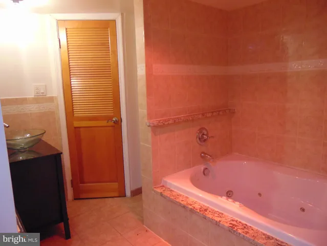 a bathroom with a tub and shower