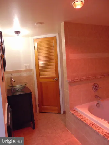 a bathroom with a bathtub and a sink