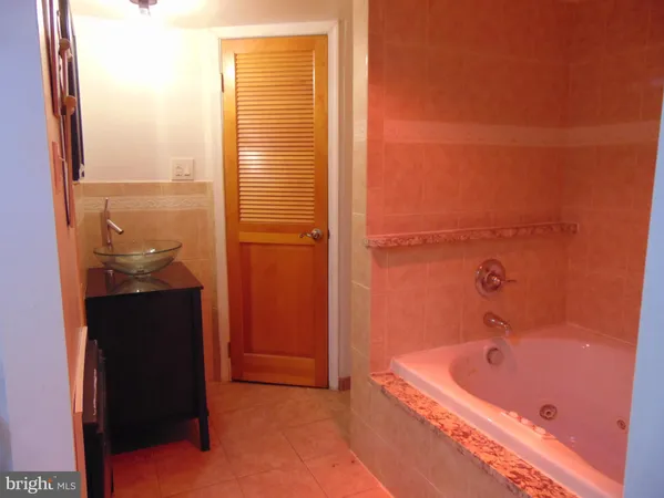 a bathroom with a tub and shower