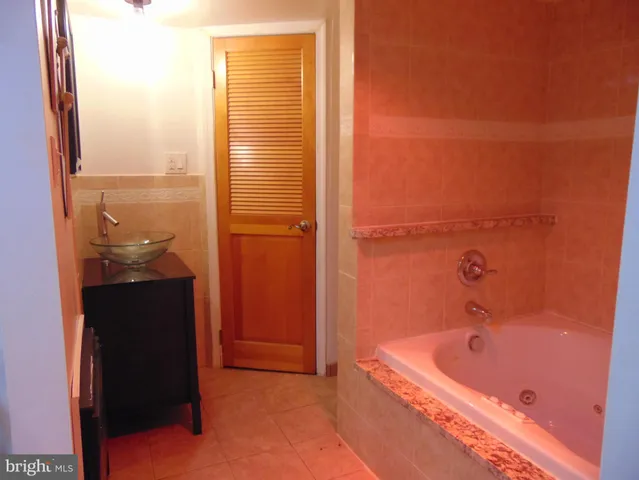 a bathroom with a tub and shower