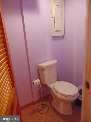 a white toilet sitting next to a small sink