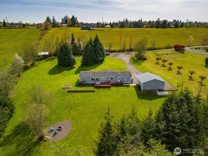 an aerial view of a house with a swimming pool outdoor seating and yard