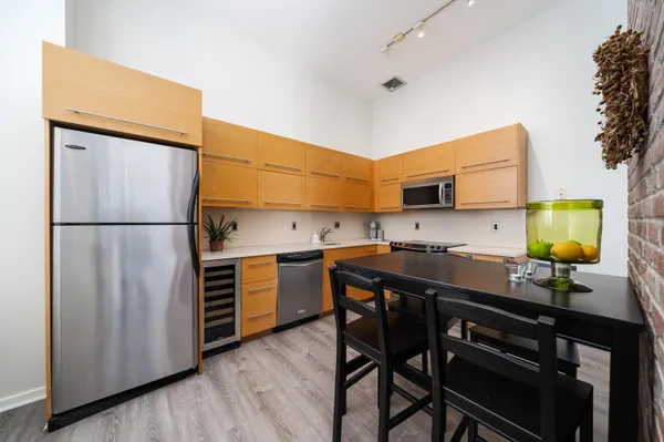 a kitchen with stainless steel appliances a stove a sink and a refrigerator