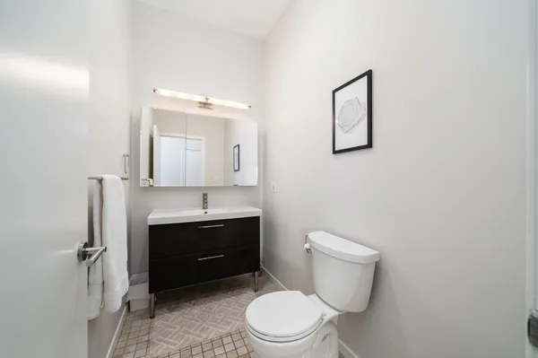 a bathroom with a toilet a sink and mirror