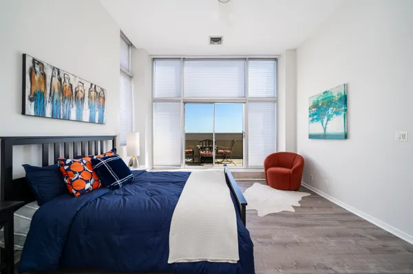 a bed room with a bed and a chair