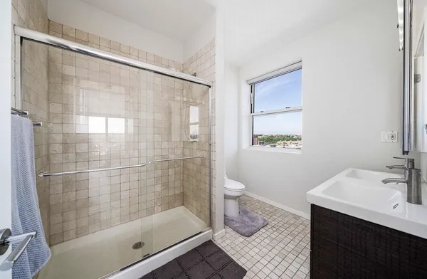 a bathroom with a shower and a sink