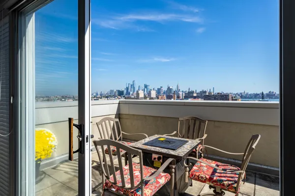 a balcony with a table and chairs