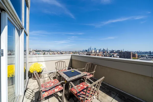 a terrace with outdoor seating and city view