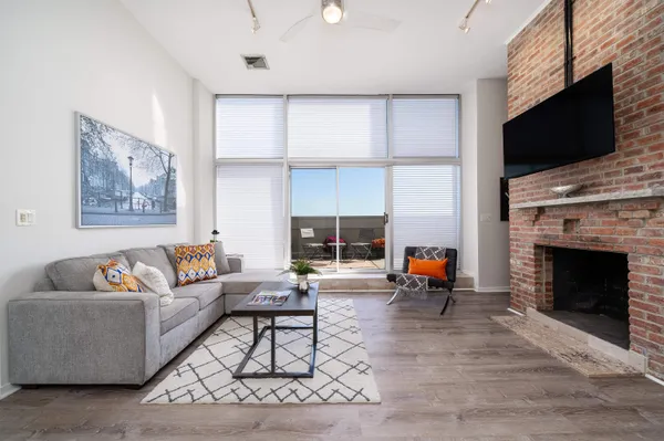 a living room with furniture and a fireplace