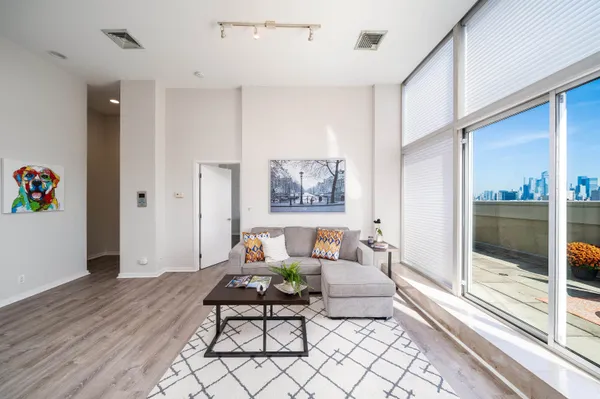 a living room with furniture and a floor to ceiling window