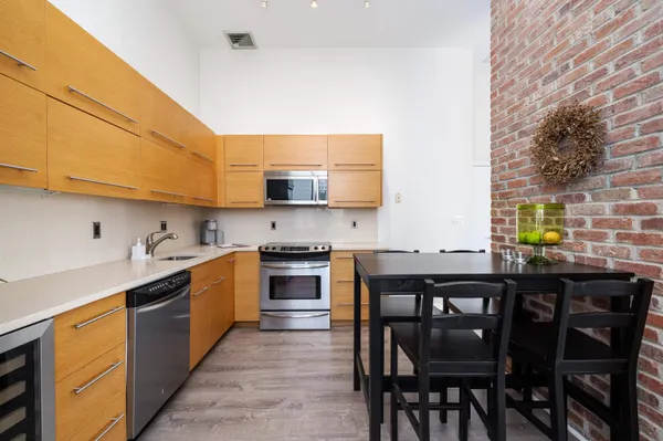 a kitchen with stainless steel appliances kitchen island granite countertop a sink and cabinets