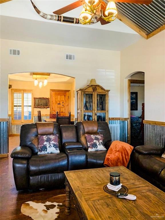 2938 Highway 83 Roma, TX 78584 - Photo 5 of 23 Living room with a chandelier, arched walkways, and wood finished floors