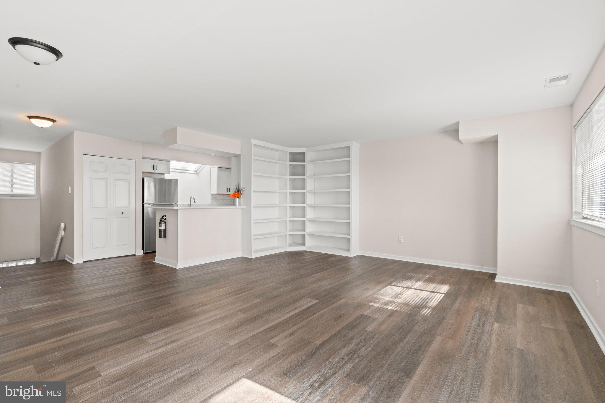 1210 Thackery Court Sicklerville, NJ 08081 - Photo 11 of 18 a view of empty room with wooden floor and kitchen