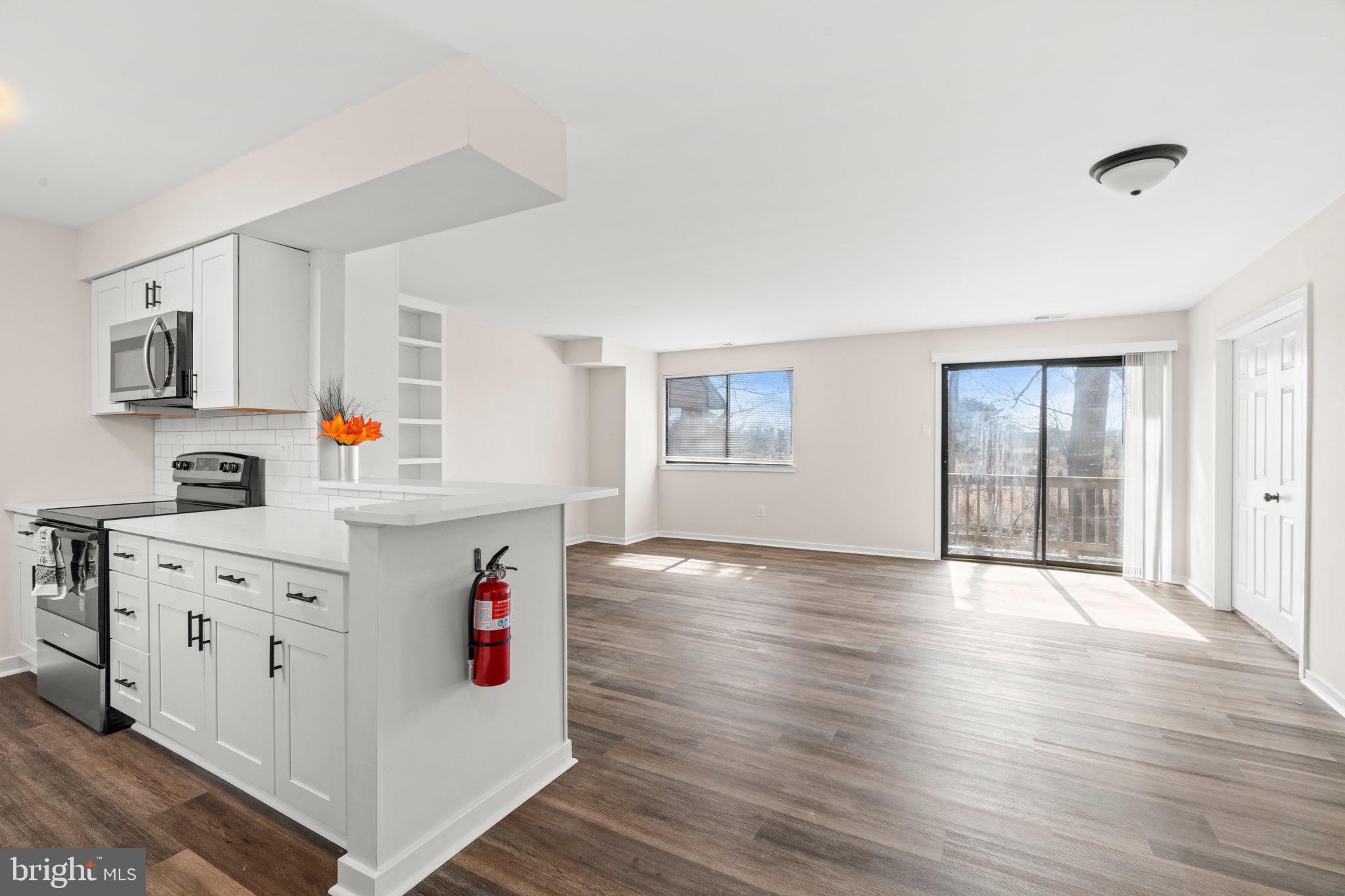 1210 Thackery Court Sicklerville, NJ 08081 - Photo 4 of 18 a kitchen with cabinets a stove and wooden floor