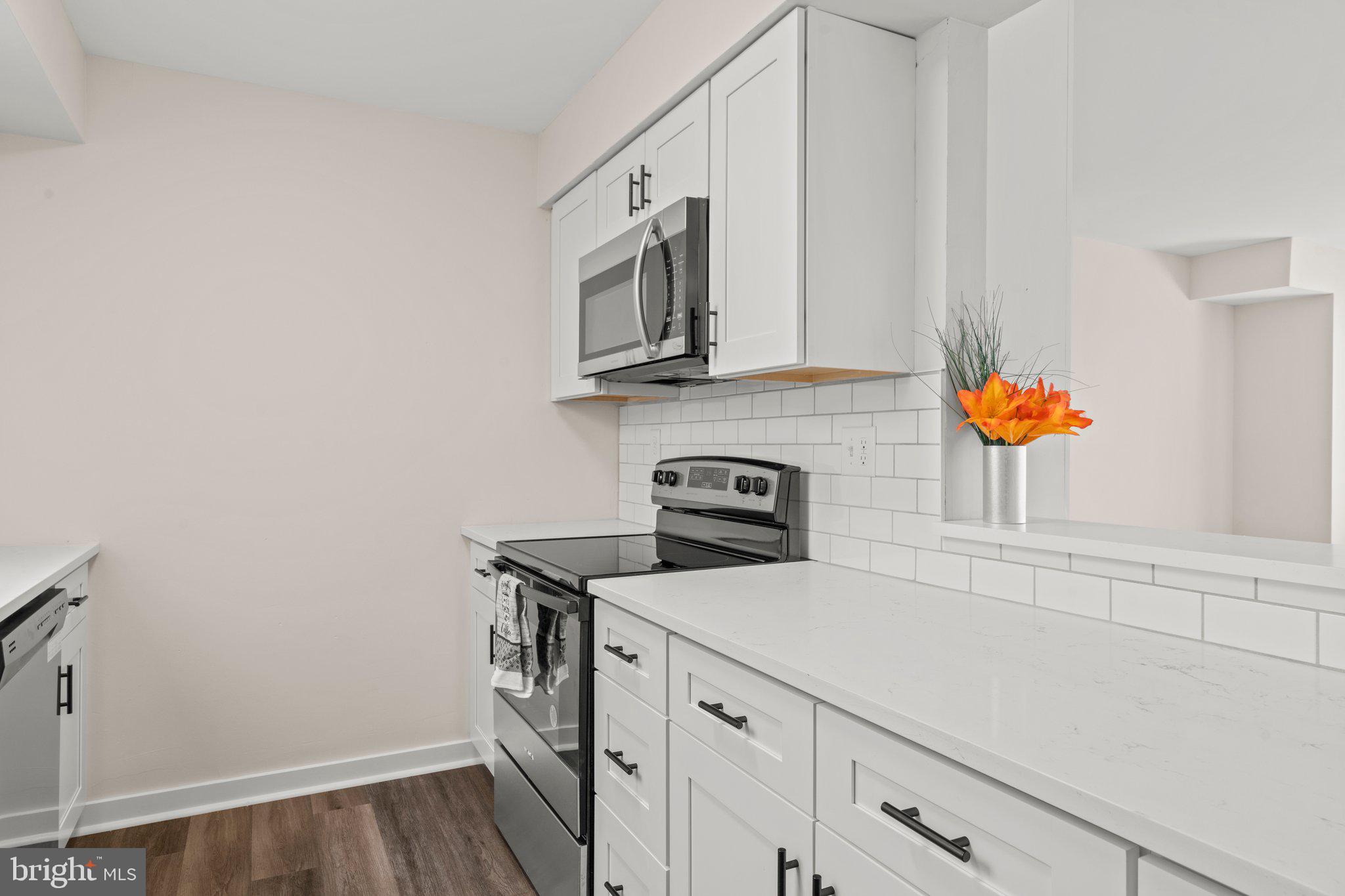 1210 Thackery Court Sicklerville, NJ 08081 - Photo 7 of 18 a kitchen with stainless steel appliances a sink a stove and cabinets
