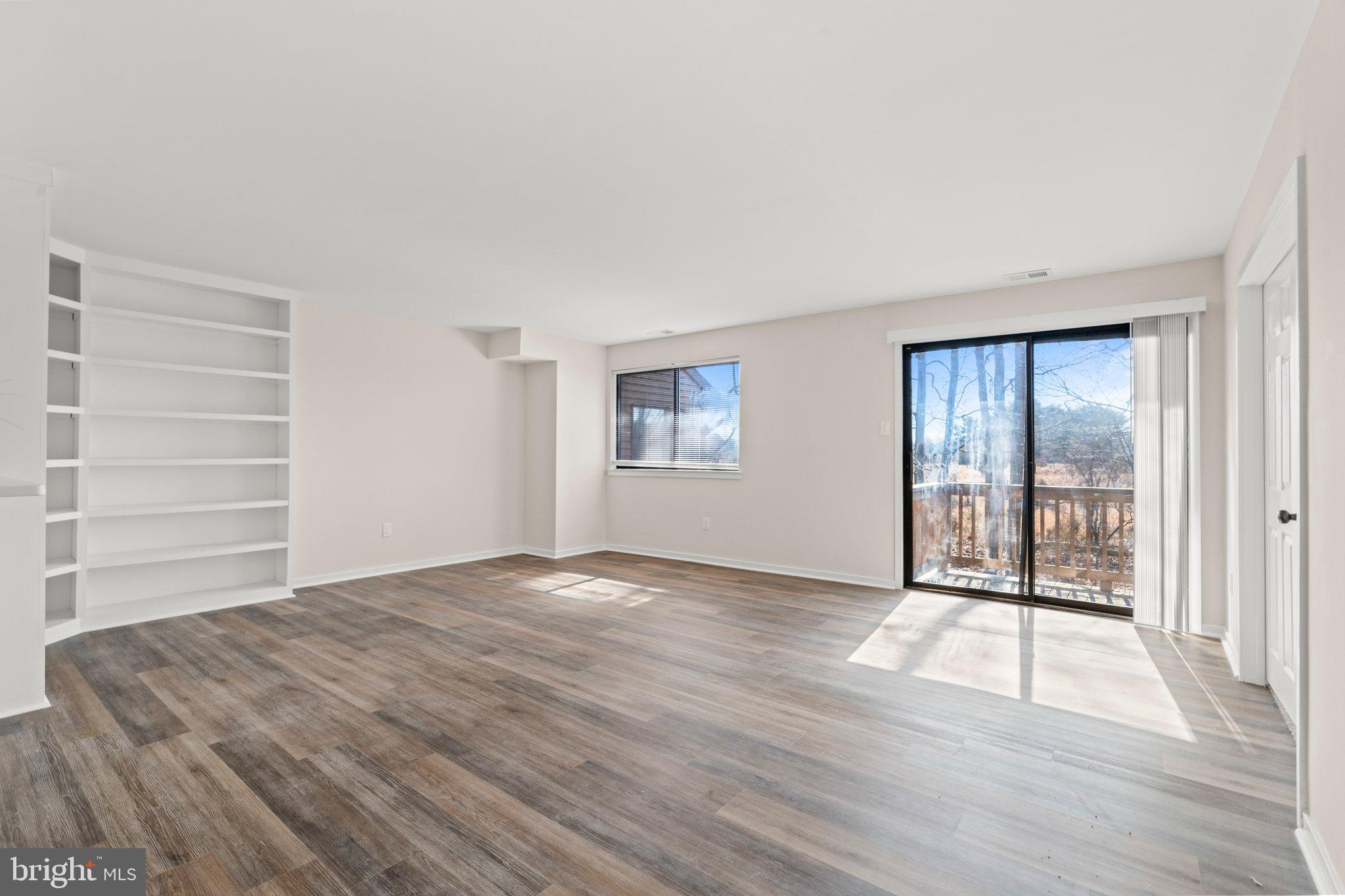 1210 Thackery Court Sicklerville, NJ 08081 - Photo 10 of 18 a view of an empty room with a window and wooden floor