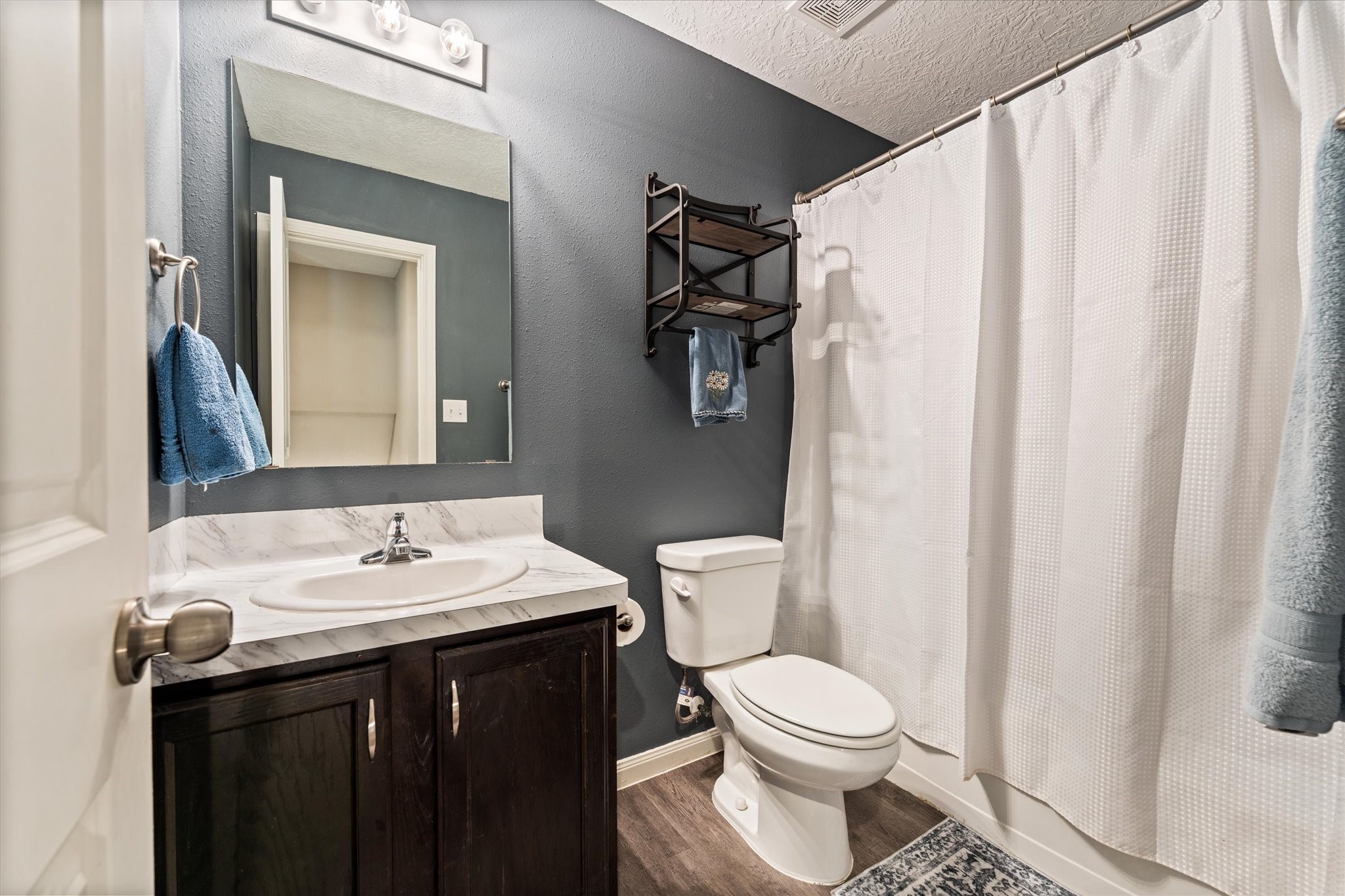 3998 Frontier Road Willis, TX 77378 - Photo 26 of 33 a bathroom with a sink a toilet and shower