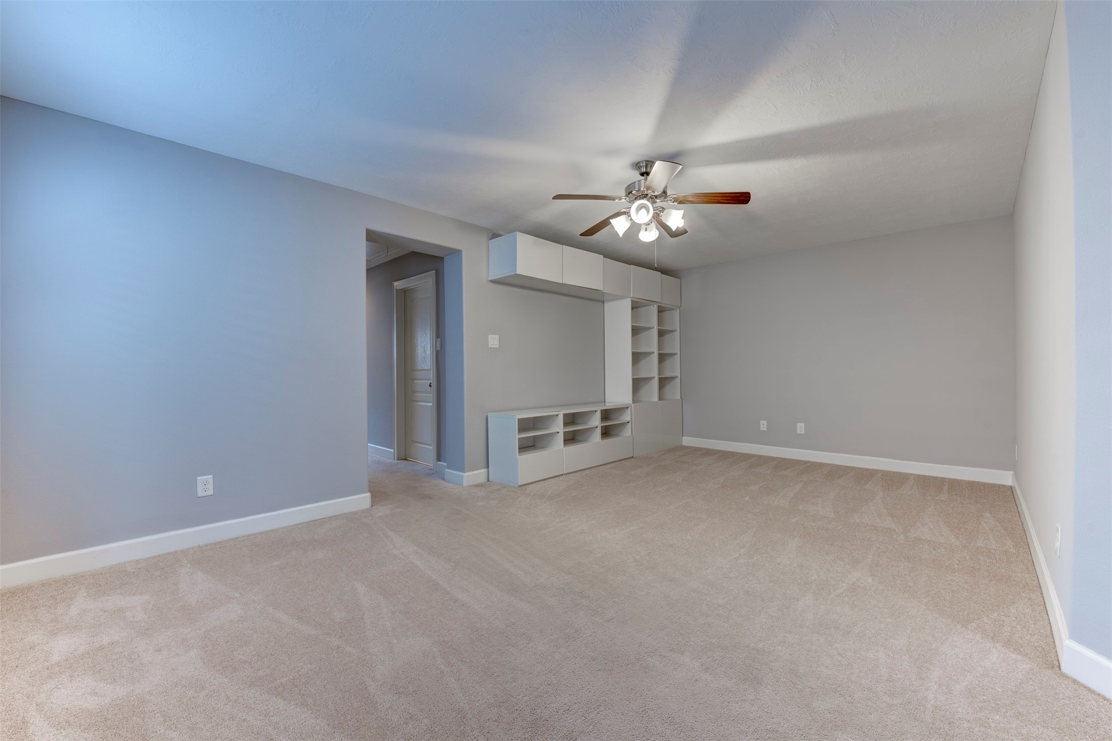1811 Wichita Street, Unit A Houston, TX 77004 - Photo 15 of 36 an empty room with chandelier fan and windows