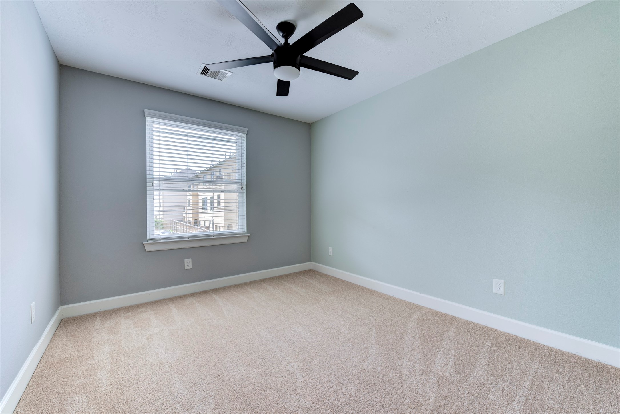 1811 Wichita Street, Unit A Houston, TX 77004 - Photo 27 of 36 an empty room with windows and fan