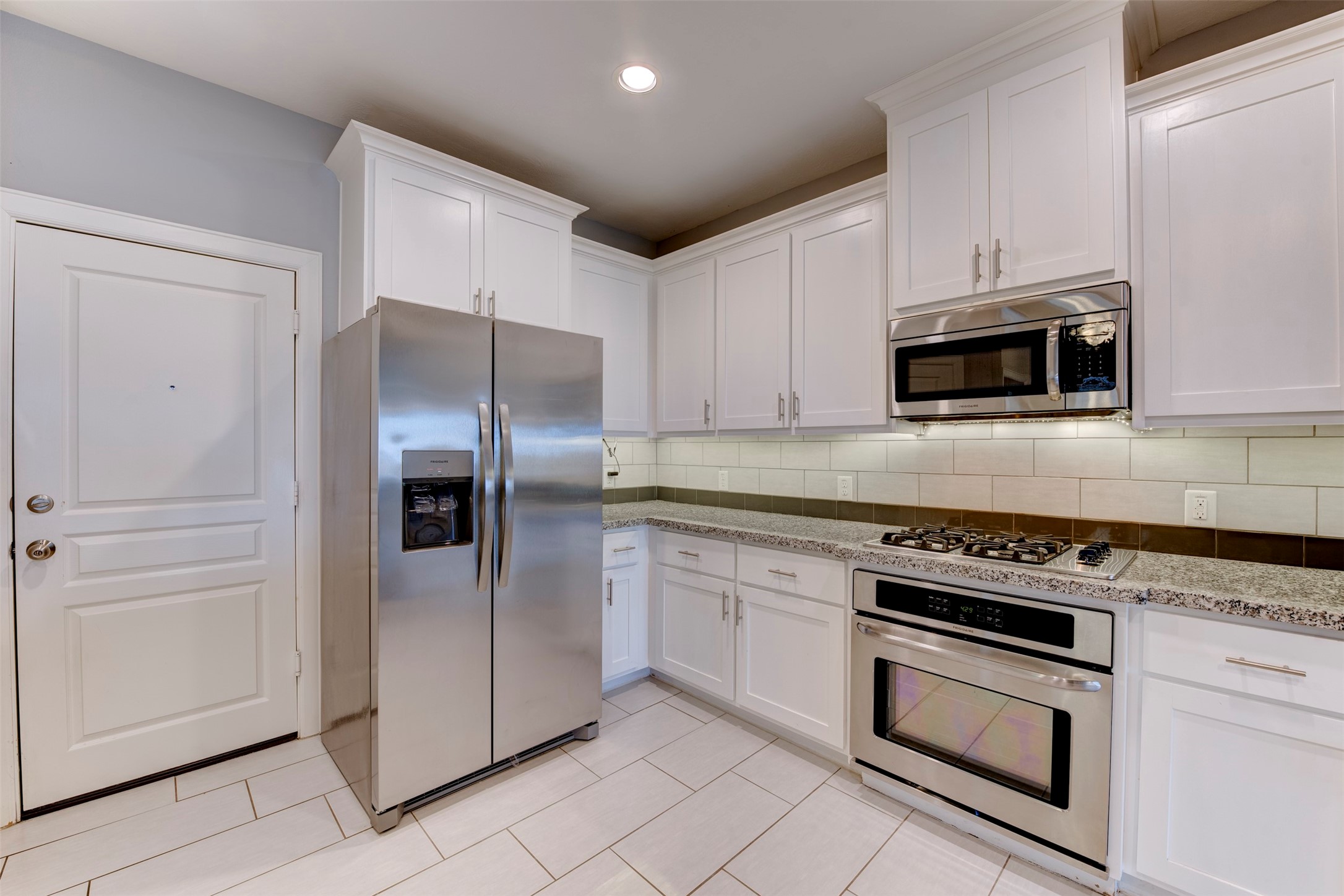 1811 Wichita Street, Unit A Houston, TX 77004 - Photo 5 of 36 a kitchen with granite countertop cabinets and steel stainless steel appliances
