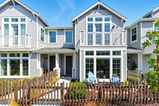 front view of a large residential apartment building with a yard