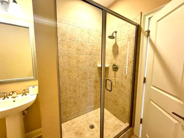 a bathroom with a shower and a sink