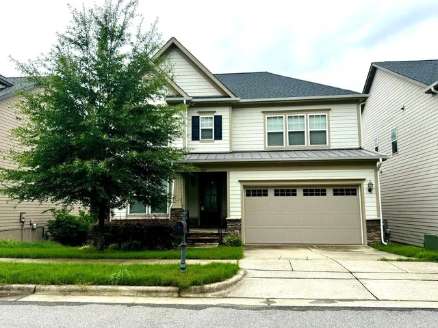 a front view of a house with a garden