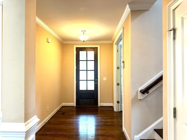 a view of entryway with wooden floor and stairs
