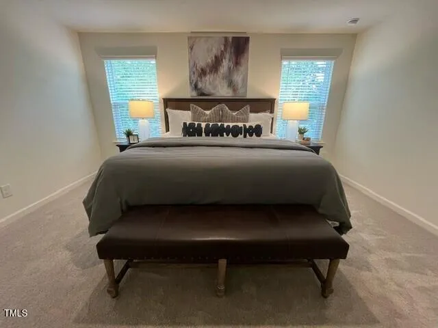 a bed sitting in a bedroom next to a window