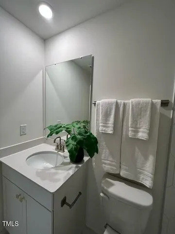 a bathroom with a sink toilet and mirror