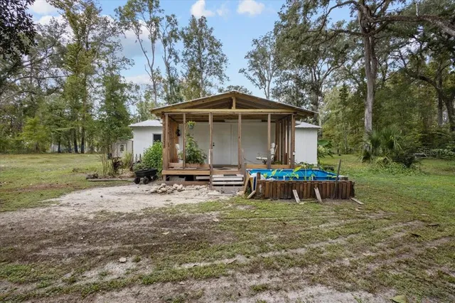 a backyard of a house with table and chairs
