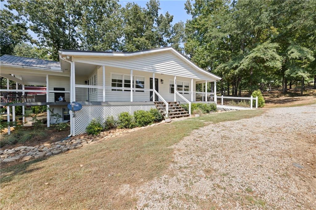 1631 Arrowhead Road Greensboro, GA 30642 - Photo 3 of 83 a front view of a house with a yard and potted plants