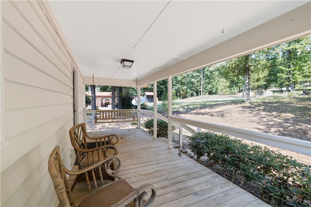 1631 Arrowhead Road Greensboro, GA 30642 - Photo 35 of 83 a view of a patio with table and chairs with wooden floor and plants