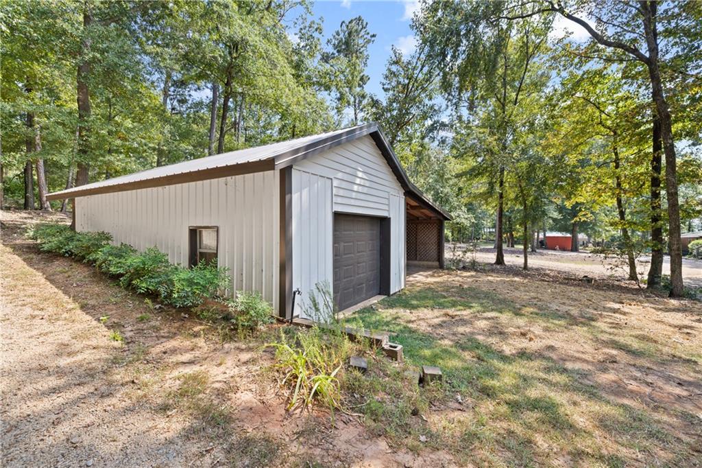 1631 Arrowhead Road Greensboro, GA 30642 - Photo 36 of 83 a backyard of a house with plants and large tree