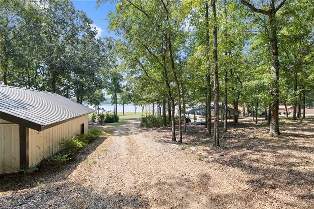 1631 Arrowhead Road Greensboro, GA 30642 - Photo 38 of 83 a backyard of a house with trees