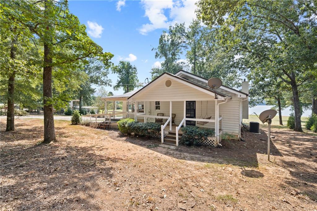 1631 Arrowhead Road Greensboro, GA 30642 - Photo 59 of 83 a front view of a house with a yard and trees