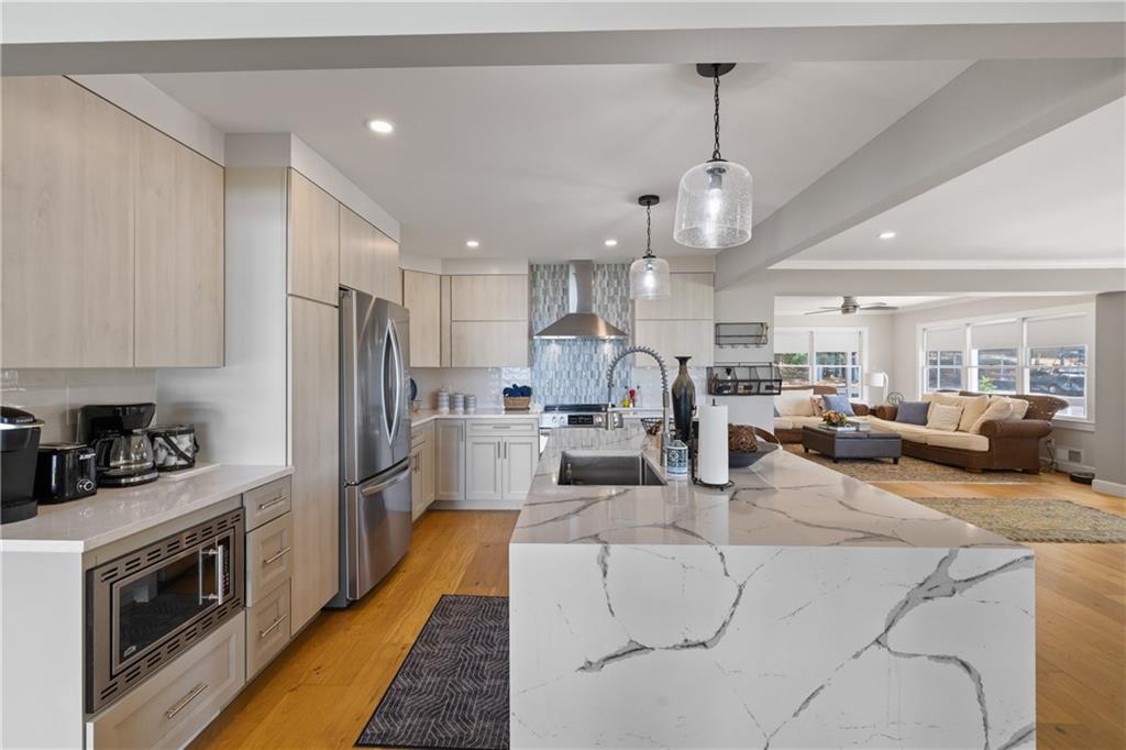 1631 Arrowhead Road Greensboro, GA 30642 - Photo 78 of 83 a kitchen with stainless steel appliances kitchen island granite countertop a dining table chairs refrigerator and microwave