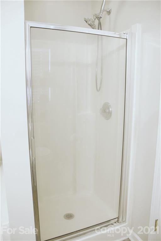 13415 Philip Michael Road Huntersville, NC 28078 - Photo 22 of 30 a bathroom with a glass shower door