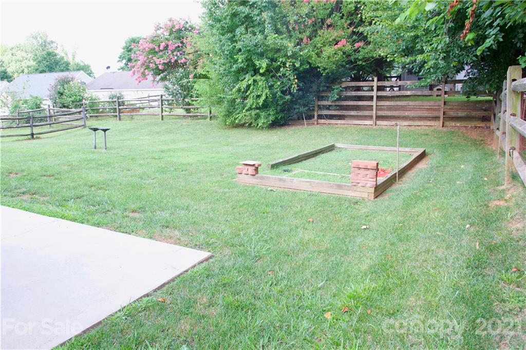 13415 Philip Michael Road Huntersville, NC 28078 - Photo 8 of 30 a view of a backyard with lawn chairs and large trees