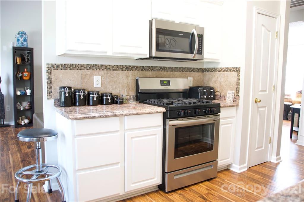 13415 Philip Michael Road Huntersville, NC 28078 - Photo 9 of 30 a kitchen with a stove and a microwave