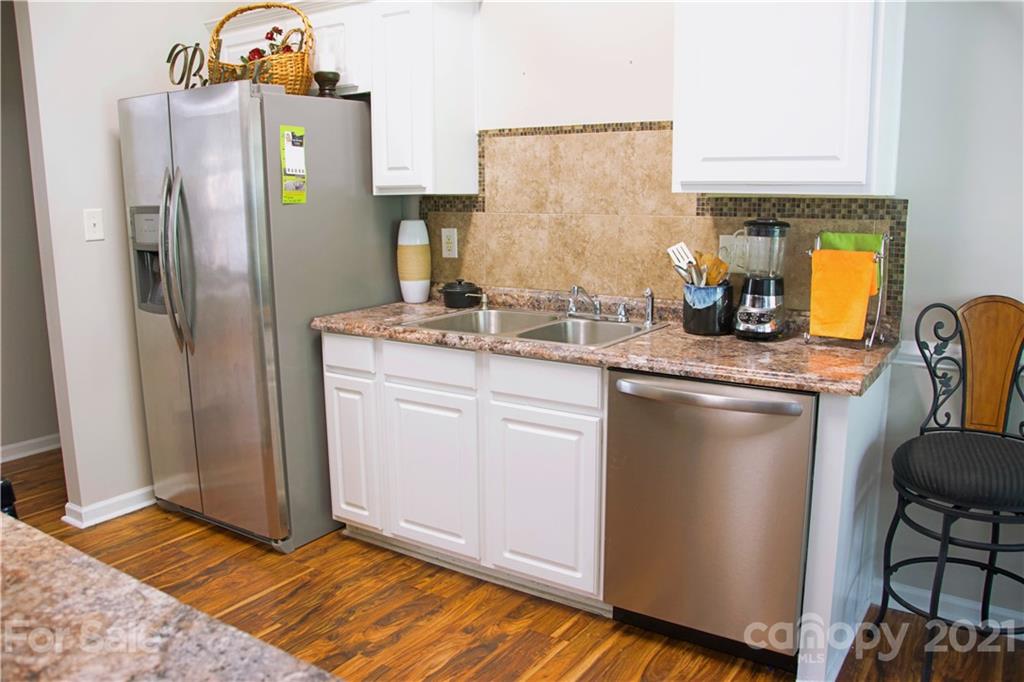 13415 Philip Michael Road Huntersville, NC 28078 - Photo 10 of 30 a kitchen with stainless steel appliances granite countertop a refrigerator and a stove
