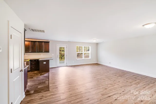 a view of a kitchen with a sink microwave and cabinets