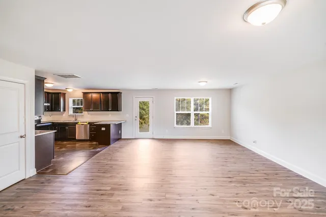 a view of kitchen with furniture and wooden floor